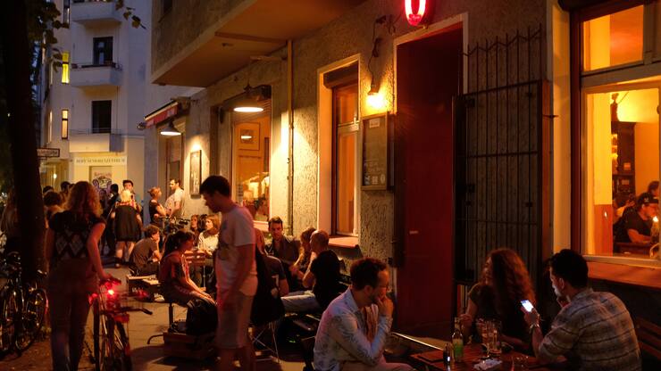 BERLIN, GERMANY - JUNE 02: People hang out at outdoor tables on the sidewalk at Oblomov bar on a warm evening in Neukoelln district on June 2, 2018 in Berlin, Germany. Many restaurants and bars offer outdoor seating during the warm summer months.  (Photo by Sean Gallup/Getty Images)