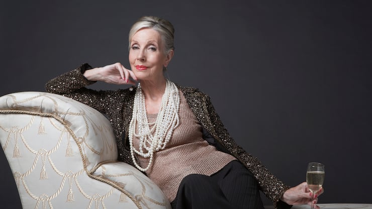 Reichtum Vermögen Perlenkette Champagner Frau Sofa