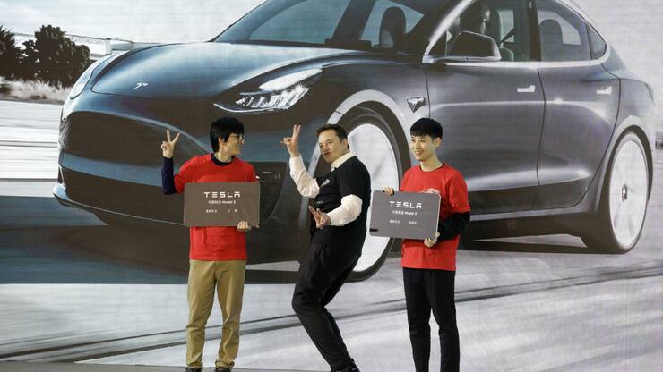 Elon Musk, chief executive officer of Tesla Inc., gestures during the Tesla China-Made Model 3 Delivery Ceremony at the company's Gigafactory in Shanghai, China, on Tuesday, Jan. 7, 2020. Tesla kicked off production in China, marking a major step in Musks global push for electric-vehicle domination and heralding what could be the dawn of real competition in the worlds largest EV market. Photographer: Qilai Shen/Bloomberg