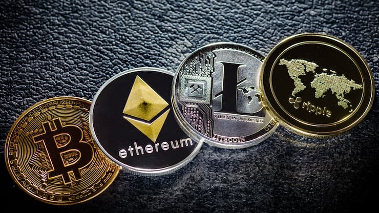 Berlin, Germany - April 10: In this photo illustration coins of the crypto currencies bitcoin, ethereum litecoin and ripple stands on a hard disk on April 10, 2018 in Berlin, Germany. (Photo Illustration by Thomas Trutschel/Photothek via Getty Images)