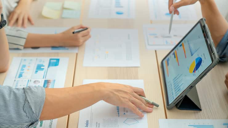 Close-up shot of Business Colleagues teamwork analyzing financial data at the table in modern office about business strategies.