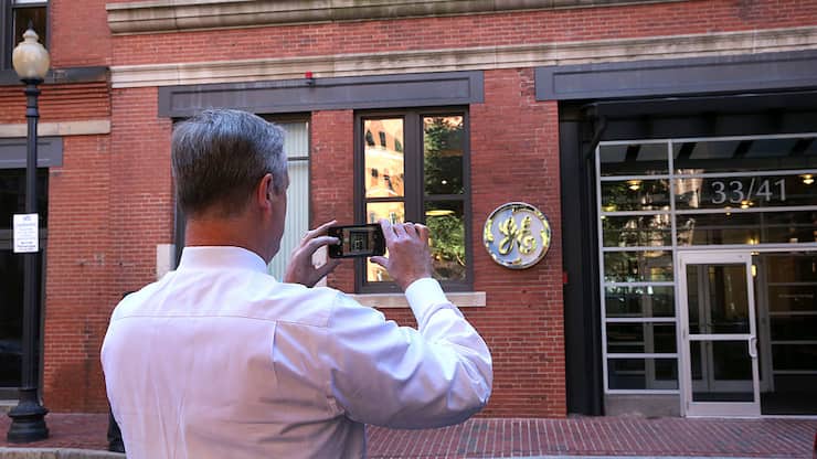 BOSTON, MA - AUGUST 22: Gov. CharlIe Baker takes a photo of the GE entrance. General Electric has opened its new headquarters in Fort Point on Farnsworth Street in Boston, Aug. 22, 2016. (Photo by David L. Ryan/The Boston Globe via Getty Images)