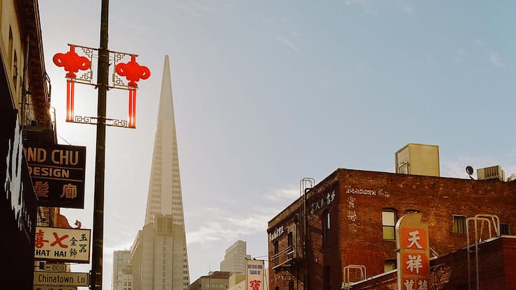 Exterior view of building and skyscraper with car parked on street, San Francisco, California, United States Of America