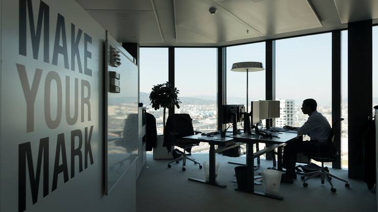 A GAM employee works at his desk in an office at the Prime Tower, a skyscraper, where the pure play asset management group GAM is headquartered, pictured in Zurich, Switzerland, on March 13, 2017. (KEYSTONE/Gaetan Bally)