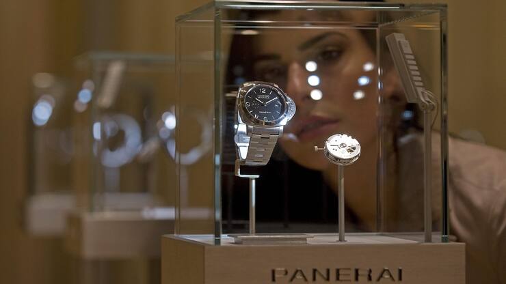 A hostess looks at a Panerai watch during the first day of the Salon International de la Haute Horlogerie in Geneva, Switzerland, Monday, January 18. 2010. The Salon International de la Haute Horlogerie celebrates its 20th year, the SIHH is a private trade fair, reserved exclusively for professionals in Fine Watchmaking who are invited by the exhibiting brands. (KEYSTONE/Sandro Campardo)
