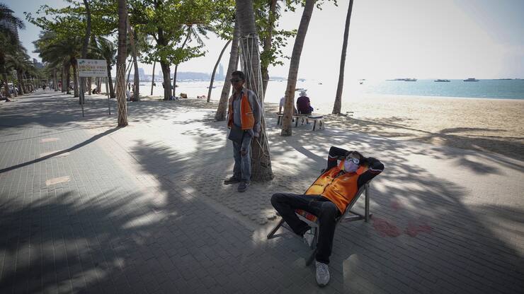 epa08278806 Motorcycle taxi drivers wait for customers by a usually busy beach in Pattaya city, Chonburi province, Thailand, 07 March 2020 (issued 08 March 2020). The novel coronavirus outbreak hit Thailand's tourism sector, as the Tourism Authority of Thailand (TAT) announced on 02 March that the number of tourists visiting the country in 2020 could drop by 6 million, the lowest in four years. EPA/DIEGO AZUBEL