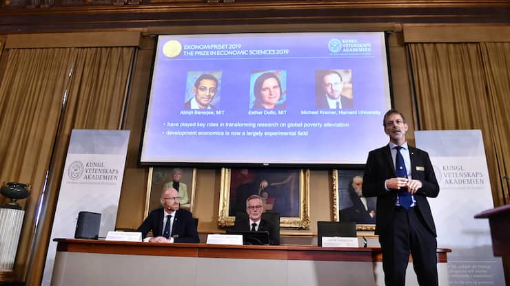 Goran K Hansson, Secretary General of the Royal Swedish Academy of Sciences, center, and academy members Peter Fredriksson, left, and Jakob Svensson announce the winners of the 2019 Nobel Prize in Economics during a news conference at the Royal Swedish Academy of Sciences in Stockholm, Sweden, Monday Oct. 14, 2019. The Nobel prize in economics has been awarded to Abhijit Banerjee, Esther Duflo and Michael Kremer "for their experimental approach to alleviating global poverty." (Karin Wesslen/TT via AP)