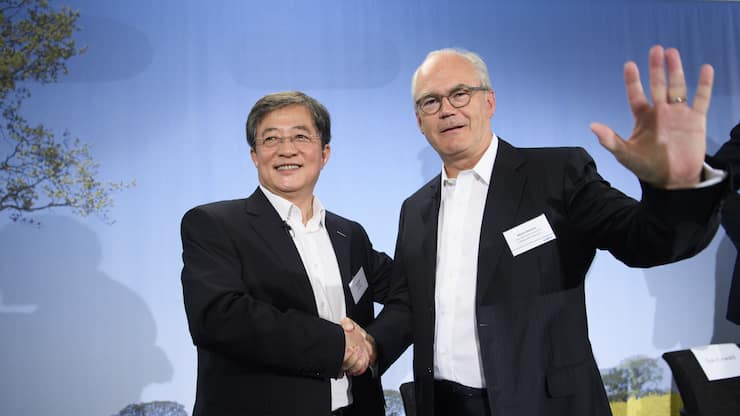Ren Jianxin, left, chairman of ChemChina and futur  Chairman of Syngenta shakes hand with Michel Demare, right, futur vice-chairman and lead independent director of Syngenta during a press conference of Syngenta after its acquisition by ChemChina, in Basel, Tuesday, June 27, 2017. The China National Chemical Corporation, or &#x201a;"ChemChina" has acquired the worlds biggest producer of agricultural chemicals, the Swiss agribusiness company Syngenta AG. (KEYSTONE/Laurent Gillieron)