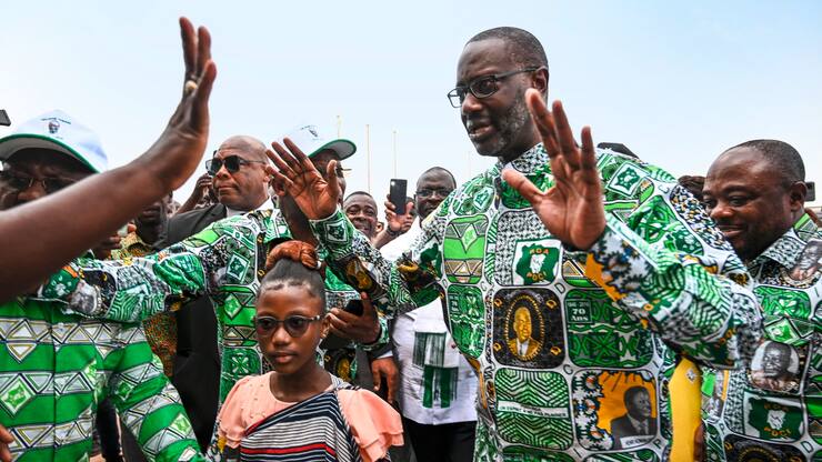 Tidjane Thiam (2nd R), former Ivorian minister and candidate for the presidency of the Democratic Party of Ivory Coast (PDCI) in 2025, arrives at the Felix Houphouet Boigny Foundation for Peace Research, for a campaign meeting in Yamoussoukro on December 9, 2023. (Photo by Sia KAMBOU / AFP)