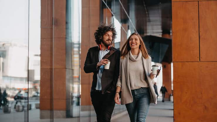 Business,Man,And,Business,Woman,Talking,And,Holding,Luggage,Traveling