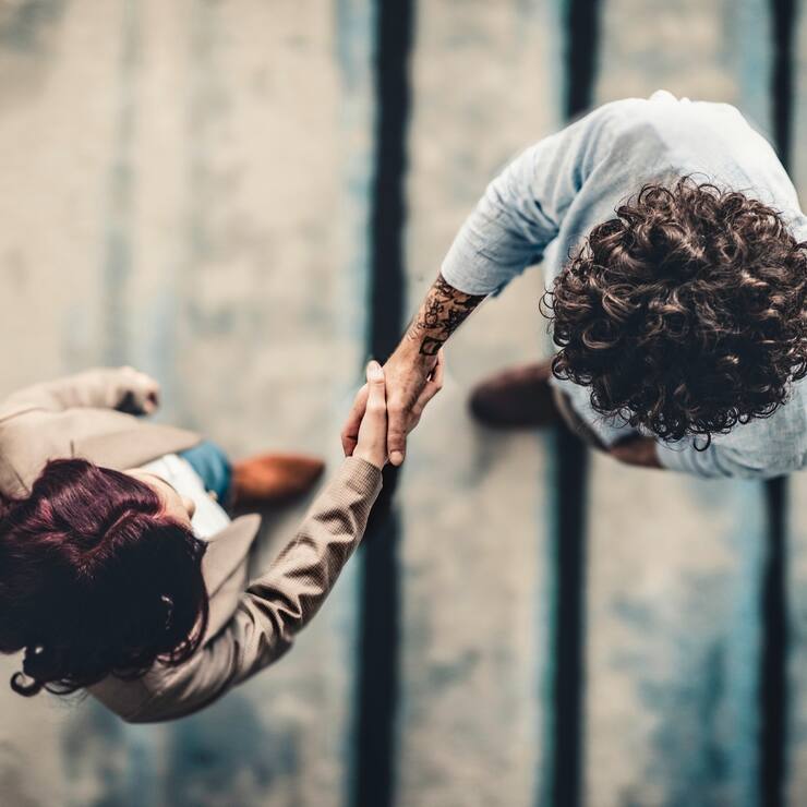 Male Manager Shaking Hands With Female Applicant