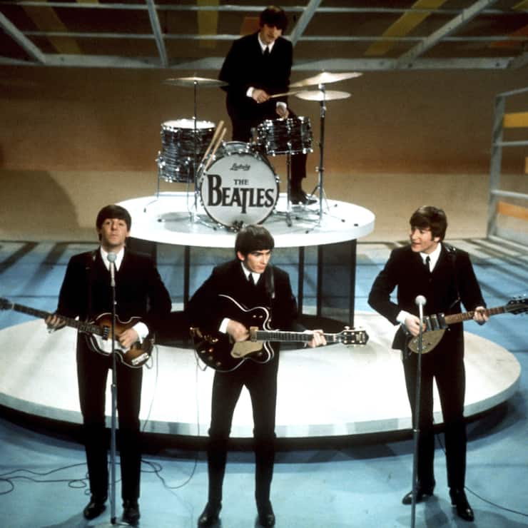 FILE -The Beatles, foreground from left, Paul McCartney, George Harrison, John Lennon and Ringo Starr, on drums, perform on the CBS "Ed Sullivan Show" in New York, Feb. 9, 1964. (AP Photo/File) Paul McCartney,George Harrison and John Lennon. Ringo Starr