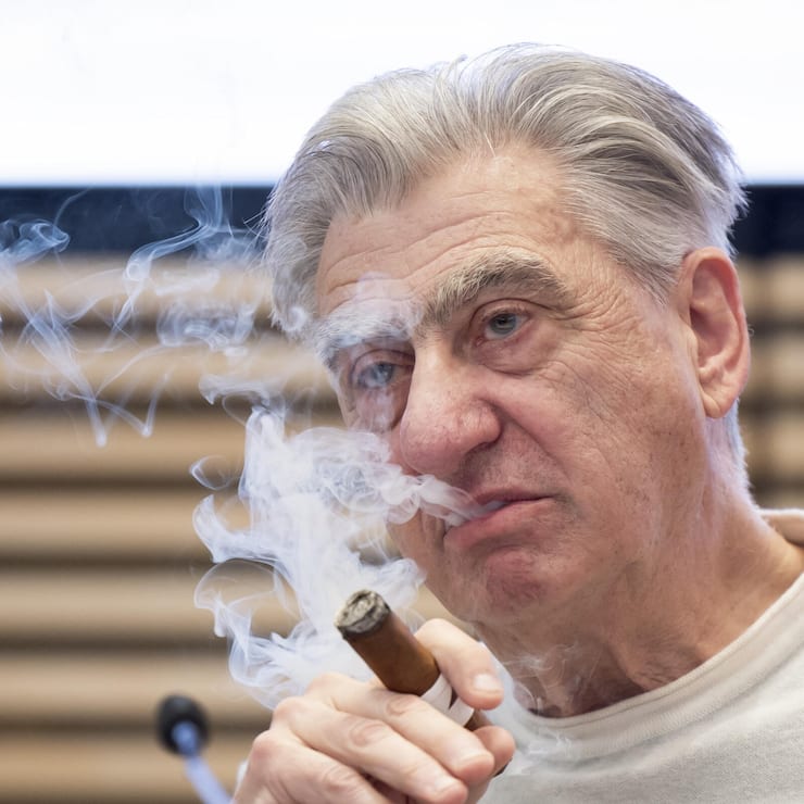 Nick Hayek, CEO Swatch Group AG, smokes a cigar during a press conference to present the annual results for 2024, Wednesday, March 19, 2025, in Biel, Switzerland. (KEYSTONE/Peter Klaunzer)
