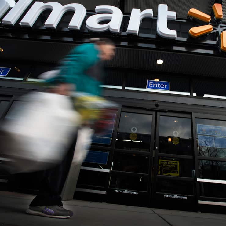 WASHINGTON, DC - DECEMBER  4: A customer departs Walmart on the opening day of the store on Georgia Ave. in Washington, DC on December 4, 2013. (Photo by Bonnie Jo Mount/The Washington Post via Getty Images)