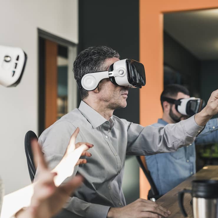 Colleagues wearing VR glasses in office