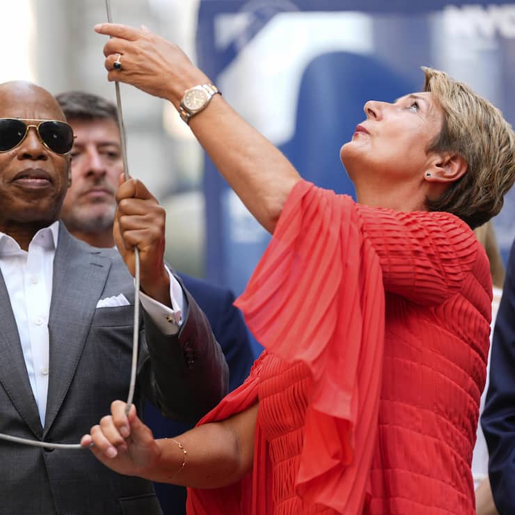 New York Mayor Eric Adams, left, and Swiss Federal Councillor Karin Keller-Sutter, right, raise an American flag during a Swiss National Day flag raising ceremony at Bowling Green, Thursday, Aug. 1, 2024, in New York. (AP Photo/Julia Nikhinson)