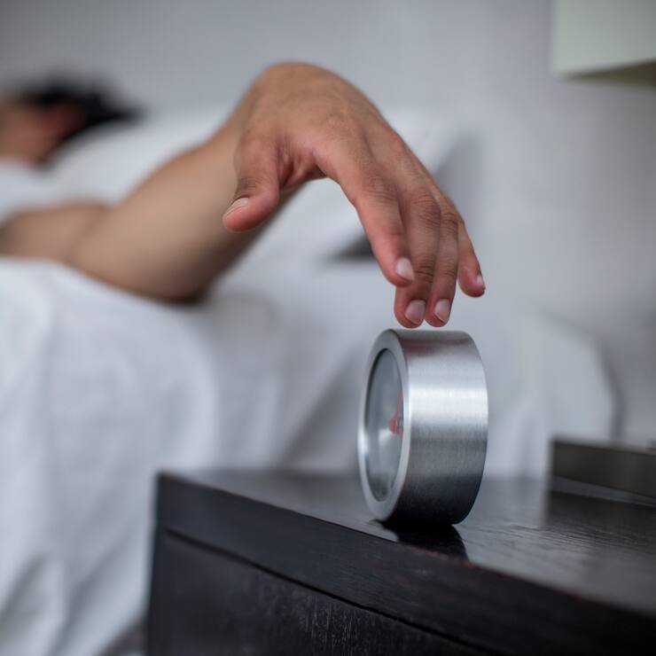 Cape Town, South Africa, young male reaches to turn off alarm clock