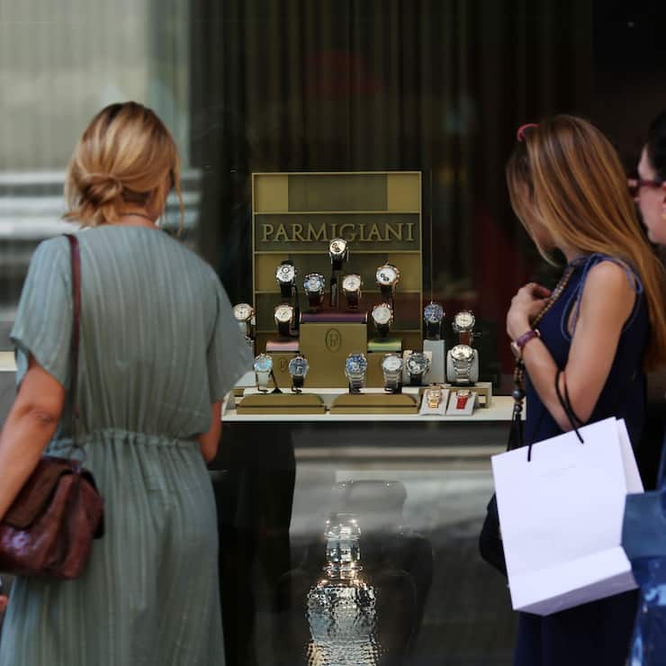 Pedestrian look at a display of Parmigiani Fleurier SA wristwatches displayed in the window of a luxury watch store in Athens, Greece, on Tuesday, July 7, 2015. Europe's most indebted country is closer than ever to an exit from the euro zone, with banks low on cash and creditor nations led by Germany running even lower on patience. Photographer: Chris Ratcliffe/Bloomberg