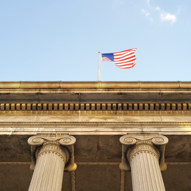 An American flag hoisted on the Federal Reserve Building in Washington, D.C.