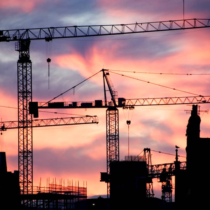 A building site at sunset with cranes silhouetted against a red sky, 2007. Artist: Historic England Staff Photographer. (Photo English Heritage/Heritage Images/Getty Images)