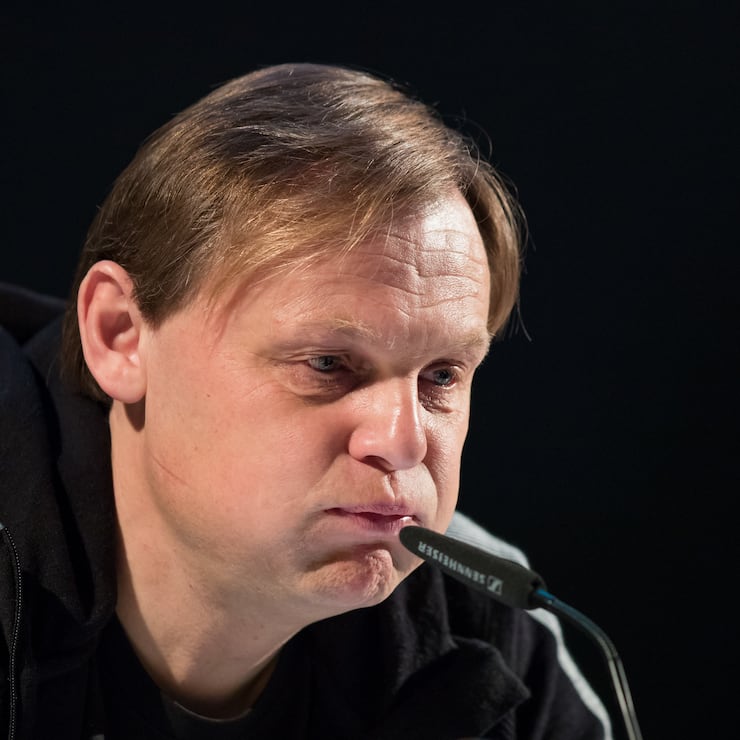 Björn Gulden, neuer CEO von Adidas, vor einem Mikrofon mit abgeschlagene Miene.