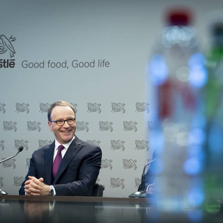 Nestle's CEO Ulf Mark Schneider smiles next to bottles of water during the 2019 full-year results press conference of the food and drinks giant Nestle, in Vevey, Switzerland, Thursday, February 13, 2020. (KEYSTONE/Laurent Gillieron)