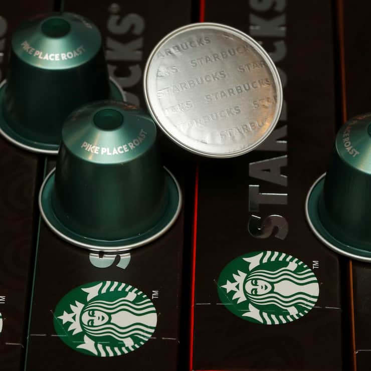Starbucks labeled single-serve coffee capsules for Nespresso coffee makers are displayed after a news conference to announce that Nestle will sell Starbucks-branded coffee at grocery stores in Europe, Asia and Latin America at the company's headquarters in Vevey, Switzerland February 13, 2019. REUTERS/Arnd Wiegmann - RC19E03273B0