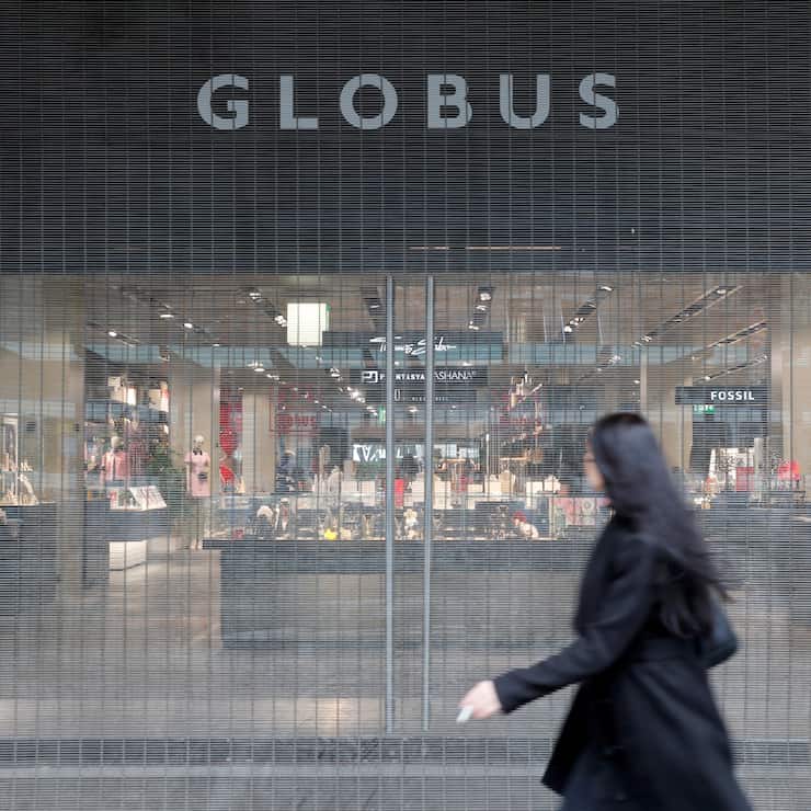 A woman walks past the entrance of a Globus department store in Zurich, Switzerland February 4, 2020. REUTERS/Arnd Wiegmann