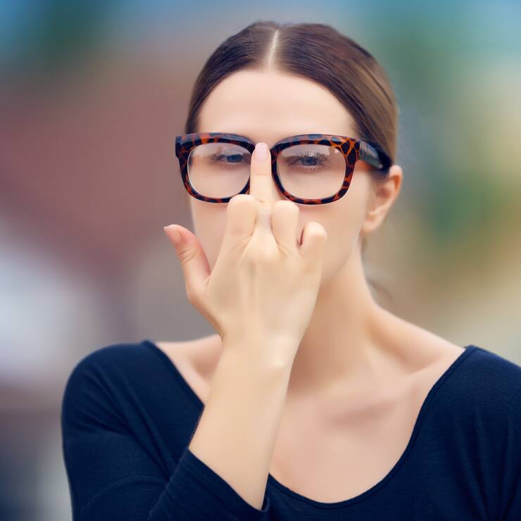 portrait of cool student with nerd eyeglasses arranging her eyewear/showing obscene gesture.