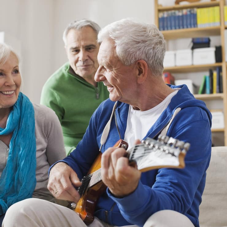 Germany, Leipzig, Senior man playing electric guitar, man and woman sitting besides model released property released PUBLICATIONxINxGERxSUIxAUTxHUNxONLY WESTF018885Germany Leipzig Senior Man Playing Electric Guitar Man and Woman Sitting besides Model released Property released PUBLICATIONxINxGERxSUIxAUTxHUNxONLY WESTF018885