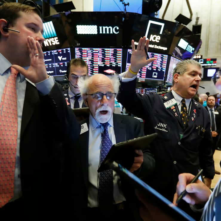 New York Stock Exchange Floor Governor Brendan Connolly, left, works with traders Peter Tuchman, John Panin and Sal Suarino, second left to right, on the floor of the NYSE, March 9, 2020. (AP Photo/Richard Drew)