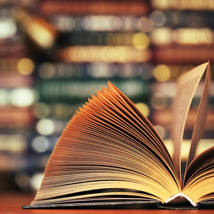 Disclosed book on a table. Close-up.