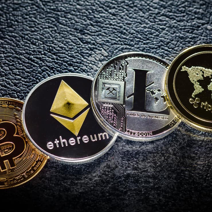 Berlin, Germany - April 10: In this photo illustration coins of the crypto currencies bitcoin, ethereum litecoin and ripple stands on a hard disk on April 10, 2018 in Berlin, Germany. (Photo Illustration by Thomas Trutschel/Photothek via Getty Images)