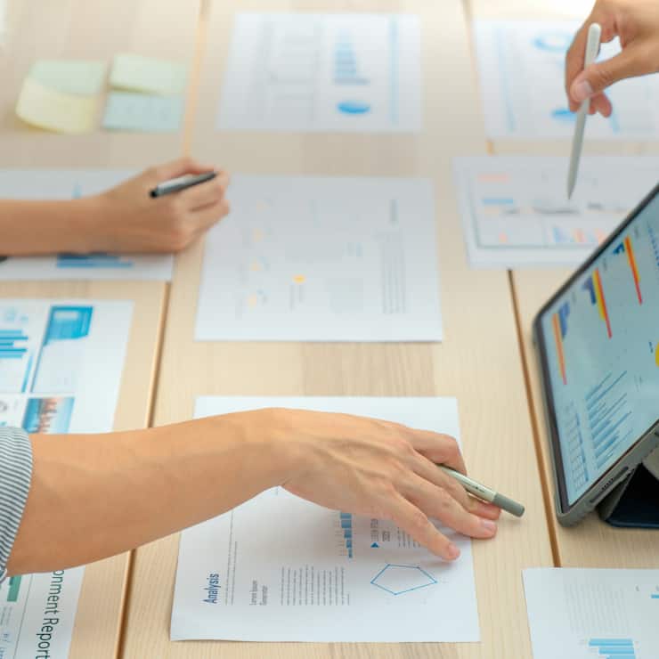 Close-up shot of Business Colleagues teamwork analyzing financial data at the table in modern office about business strategies.