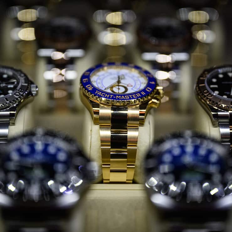 LONDON, ENGLAND - MARCH 19: A Rolex Yacht Master II (C) is seen among other items on a dealers display at the London Watch Show on March 19, 2022 in London, England. Billed as London's largest ever watch show, the London Watch Show 2022 includes display stands for luxury watch dealers, manufacturers and watch-lover lifestyle products. The event runs March 18-20 at the Grosvenor House hotel on Park Lane, London. (Photo by Leon Neal/Getty Images)