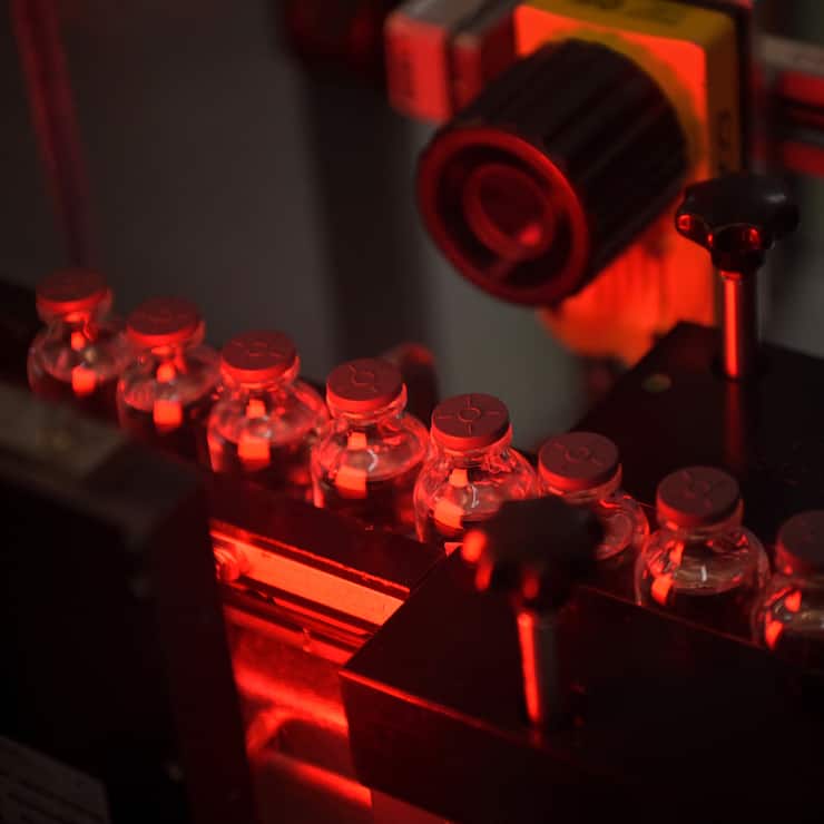 This picture taken in Monts, central France, on April 22, 2021, shows vials of the Moderna Covid-19 disease vaccine at Recipharm plant. - Recipharm has been chosen by the American biotech Moderna to produce part of its candidate vaccine against Covid-19 in France. (Photo by GUILLAUME SOUVANT / AFP)
