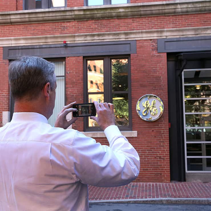 BOSTON, MA - AUGUST 22: Gov. CharlIe Baker takes a photo of the GE entrance. General Electric has opened its new headquarters in Fort Point on Farnsworth Street in Boston, Aug. 22, 2016. (Photo by David L. Ryan/The Boston Globe via Getty Images)