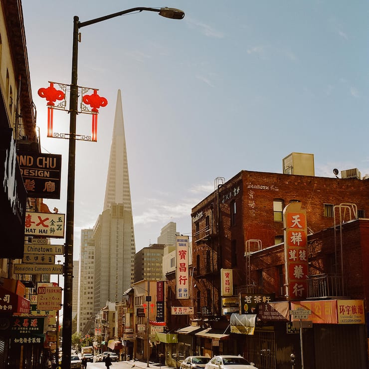 Exterior view of building and skyscraper with car parked on street, San Francisco, California, United States Of America