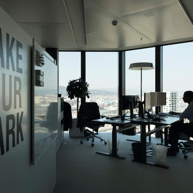 A GAM employee works at his desk in an office at the Prime Tower, a skyscraper, where the pure play asset management group GAM is headquartered, pictured in Zurich, Switzerland, on March 13, 2017. (KEYSTONE/Gaetan Bally)