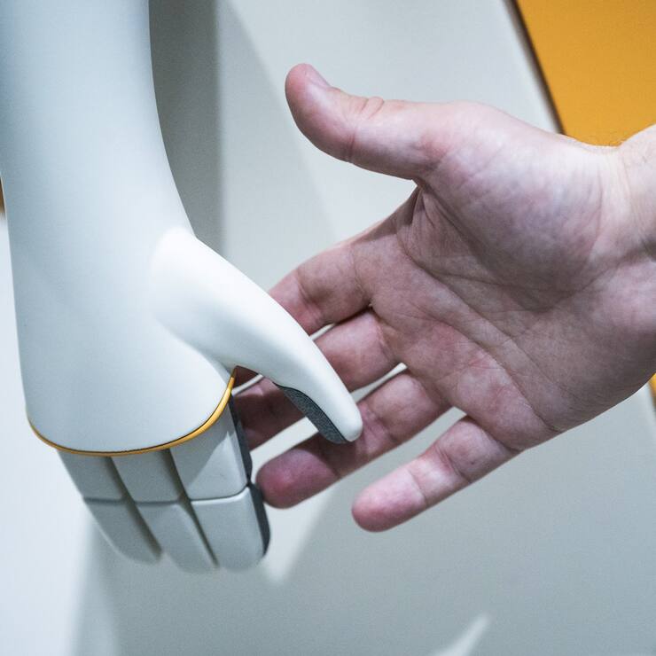 A visitor touches a PAL Robotic robot during the Mobile World Congress 2023 in Barcelona, Spain, on Wednesday, March 1, 2023. After three years of pandemic disruption, MWC, also known as Mobile World Congress, kicked off Monday in Barcelona, Spain, with mobile phone makers showing off new devices and telecom industry executives perusing the latest networking gear and software. (AP Photo/Joan Mateu Parra)