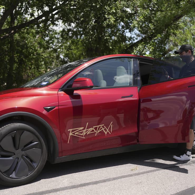 A rider boards a driverless Tesla robotaxi, a ride-booking service, Sunday, June 22, 2025, in Austin, Texas. (AP Photo/Eric Gay)