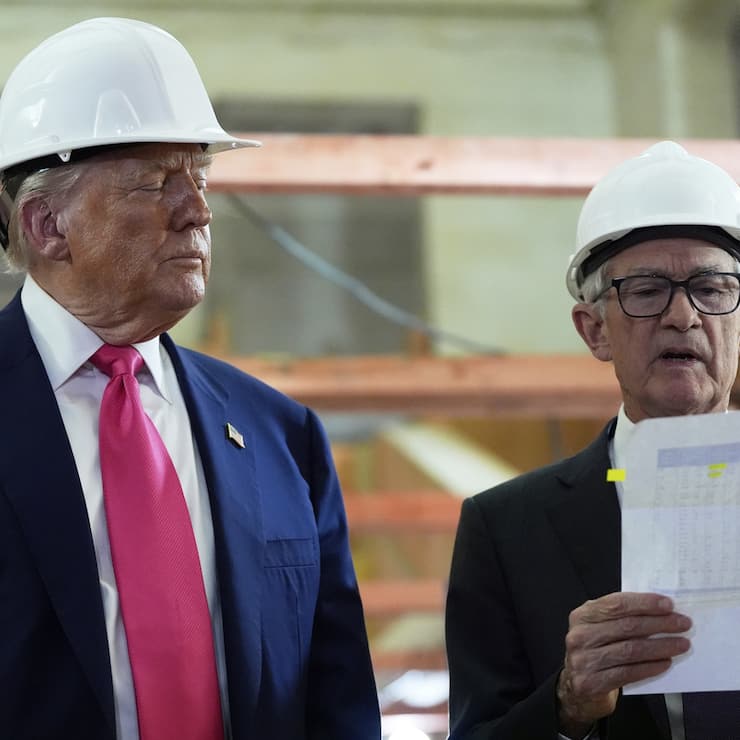 Federal Reserve Chairman Jerome Powell looks over a document of cost figures as President Donald Trump watches during a visit to the Federal Reserve, Thursday, July 24, 2025, in Washington. (AP Photo/Julia Demaree Nikhinson)