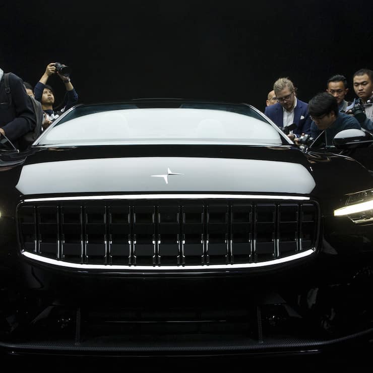 Attendees look at the the Polestar 1 during its unveiling in Shanghai, China Tuesday Oct. 17, 2017. Volvo Cars' performance electric car brand, Polestar, unveiled a four-seat coupe in lightweight carbon fiber as its first model Tuesday, adding to competition in a market dominated until now by Tesla. (Chinatopix Via AP) CHINA OUT