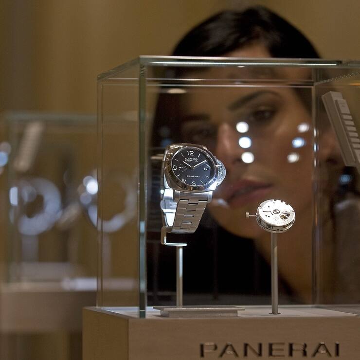 A hostess looks at a Panerai watch during the first day of the Salon International de la Haute Horlogerie in Geneva, Switzerland, Monday, January 18. 2010. The Salon International de la Haute Horlogerie celebrates its 20th year, the SIHH is a private trade fair, reserved exclusively for professionals in Fine Watchmaking who are invited by the exhibiting brands. (KEYSTONE/Sandro Campardo)