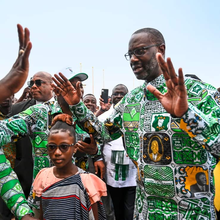 Tidjane Thiam (2nd R), former Ivorian minister and candidate for the presidency of the Democratic Party of Ivory Coast (PDCI) in 2025, arrives at the Felix Houphouet Boigny Foundation for Peace Research, for a campaign meeting in Yamoussoukro on December 9, 2023. (Photo by Sia KAMBOU / AFP)