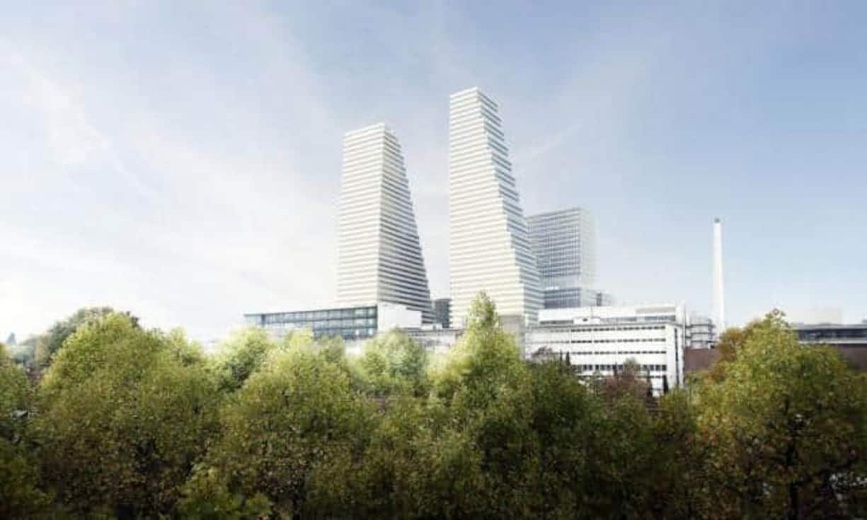 ... denn nach den Plänen von Herzog & de Meuron bekommt das Gebäude bis 2021 einen 205 Meter hohen Zwilling. Der gesamte Roche Campus soll drei Milliarden Franken kosten und wird das Gesicht der Stadt Basel grundlegend verändern. Roche