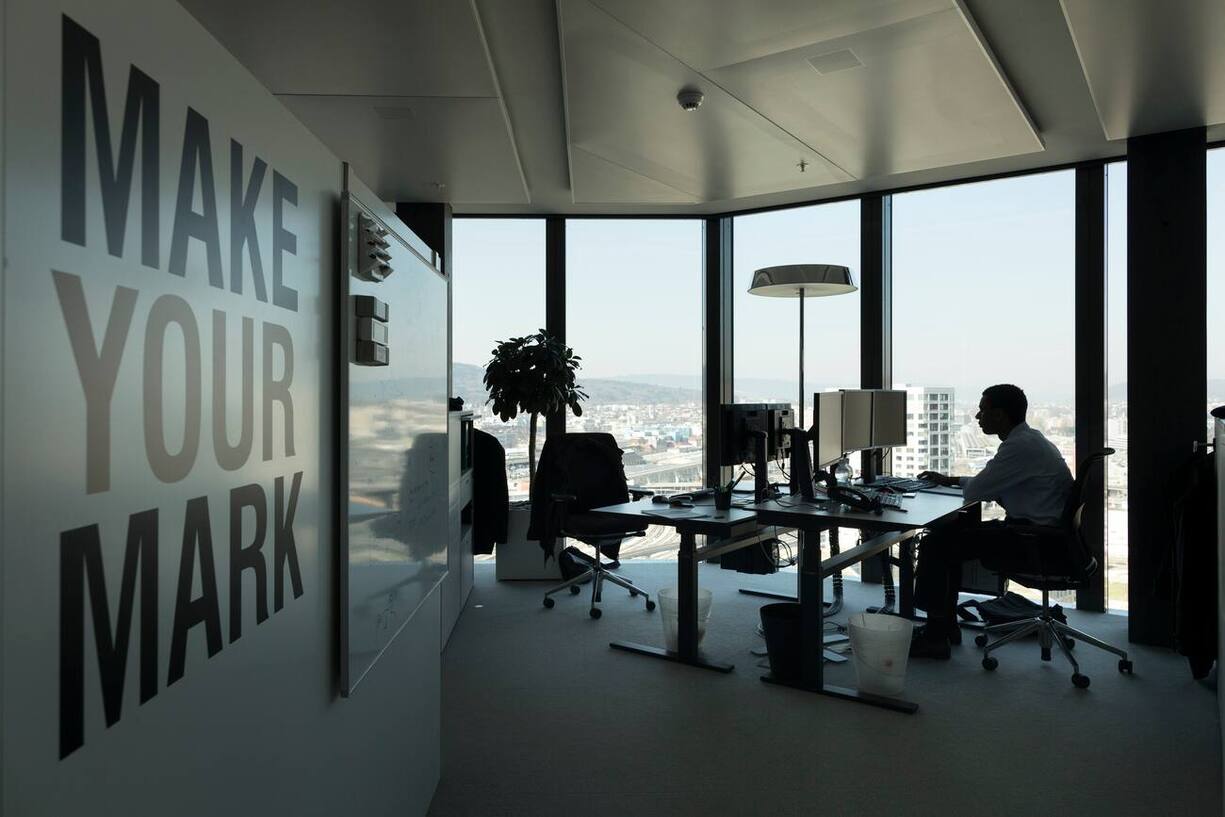 A GAM employee works at his desk in an office at the Prime Tower, a skyscraper, where the pure play asset management group GAM is headquartered, pictured in Zurich, Switzerland, on March 13, 2017. (KEYSTONE/Gaetan Bally)