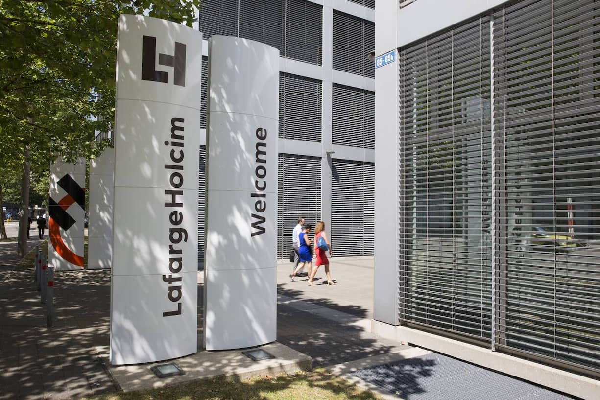 The new logo of LafargeHolcim on panels in front of the head quarters in Zurich, Switzerland, on Wednesday, 15 July 2015. LafargeHolcim today officially launched the new Group around the world and announced key elements of its ambitions for the future. (KEYSTONE/Patrick B. Kraemer)