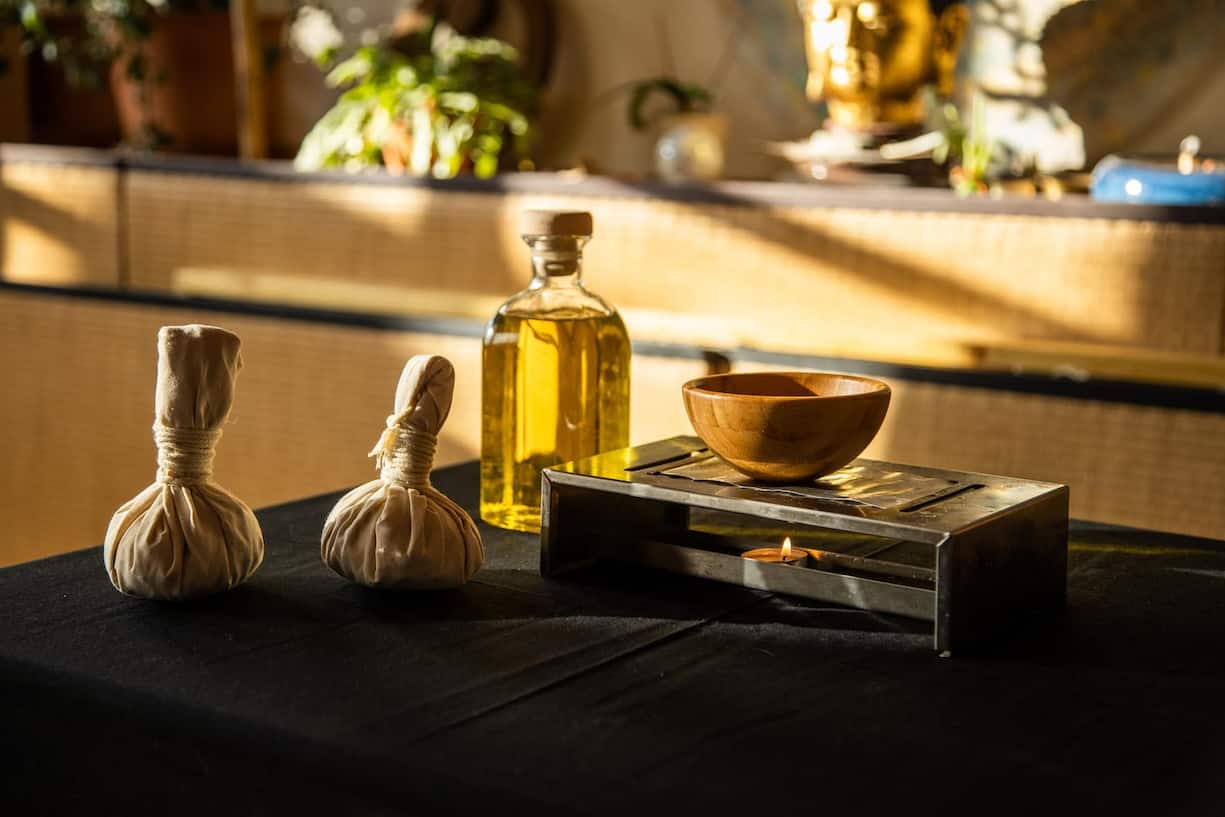 Kräuterstempel und warme Öle werden für die Behandlungen eingesetzt.