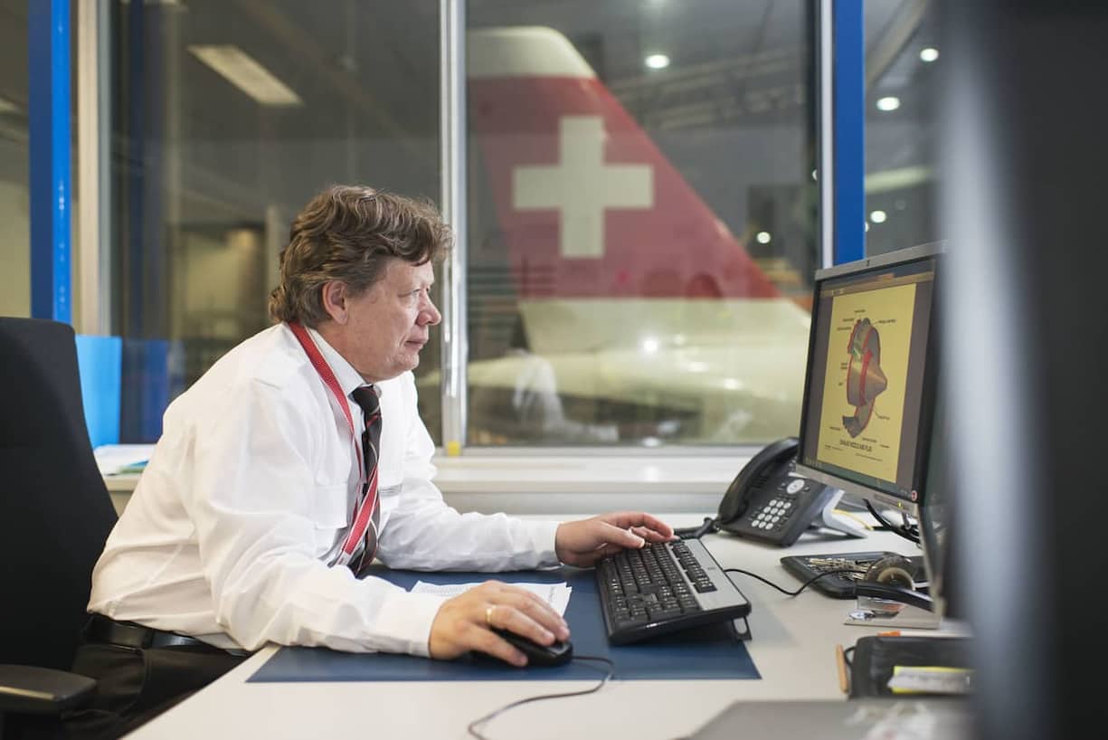 An employee prepares a maintenance at the aircraft maintenance center at Zurich Airport in Kloten in the Canton of Zurich, Switzerland, pictured on July 22, 2014. (KEYSTONE/Christian Beutler)
